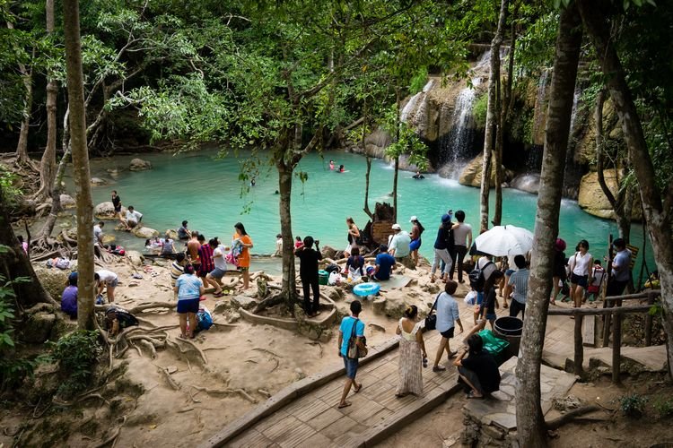 crowds at erawan falls in kanchanaburi thailand